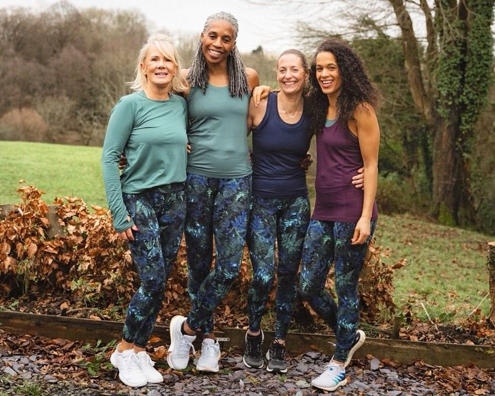 four women in matching leggings ready to work out